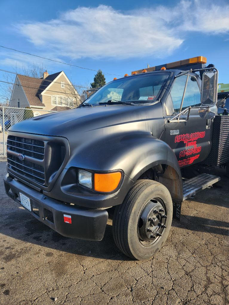 Staying Connected Towing branded towing truck in Roosevelt, NY