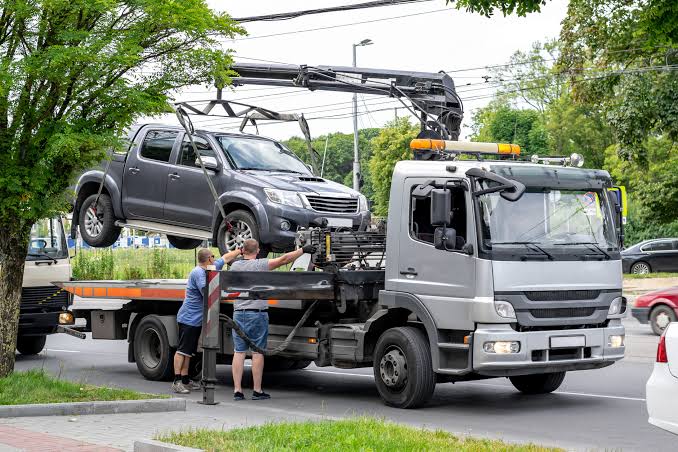 Vehicle recovery winch cable being attached